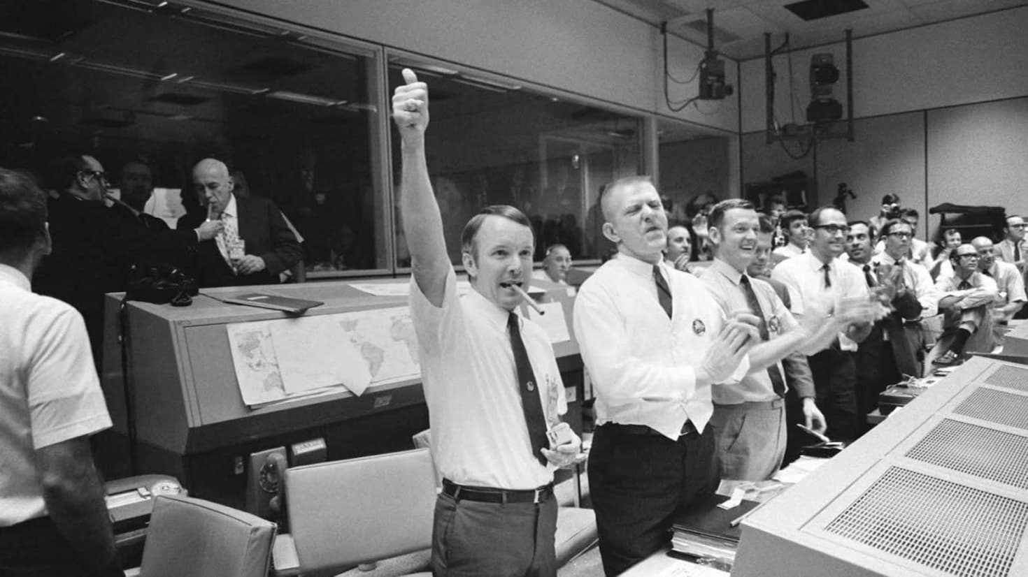 Historic photo of NASA ground control members celebrating mission success